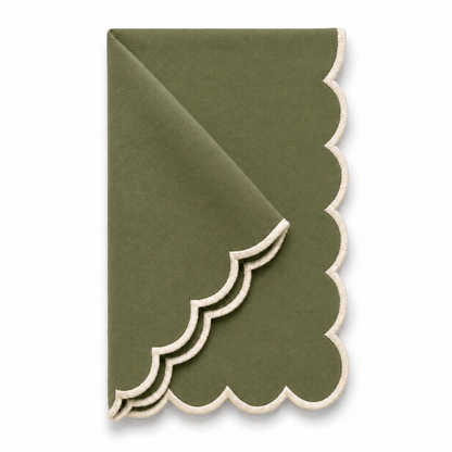 An olive green cloth napkin with a scalloped edge, folded diagonally on a clean white background.