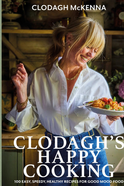 Cookbook cover featuring a woman holding a plate of food with 'Clodagh's Happy Cooking' text.