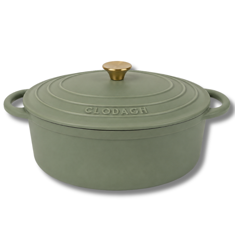 Green cast iron casserole dish with gold handle on a white background