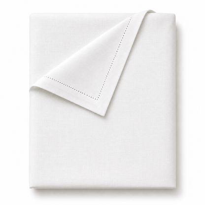 A folded white cotton table cloth with delicate double-pointed hemstitching along one corner, shown on a clean white background.