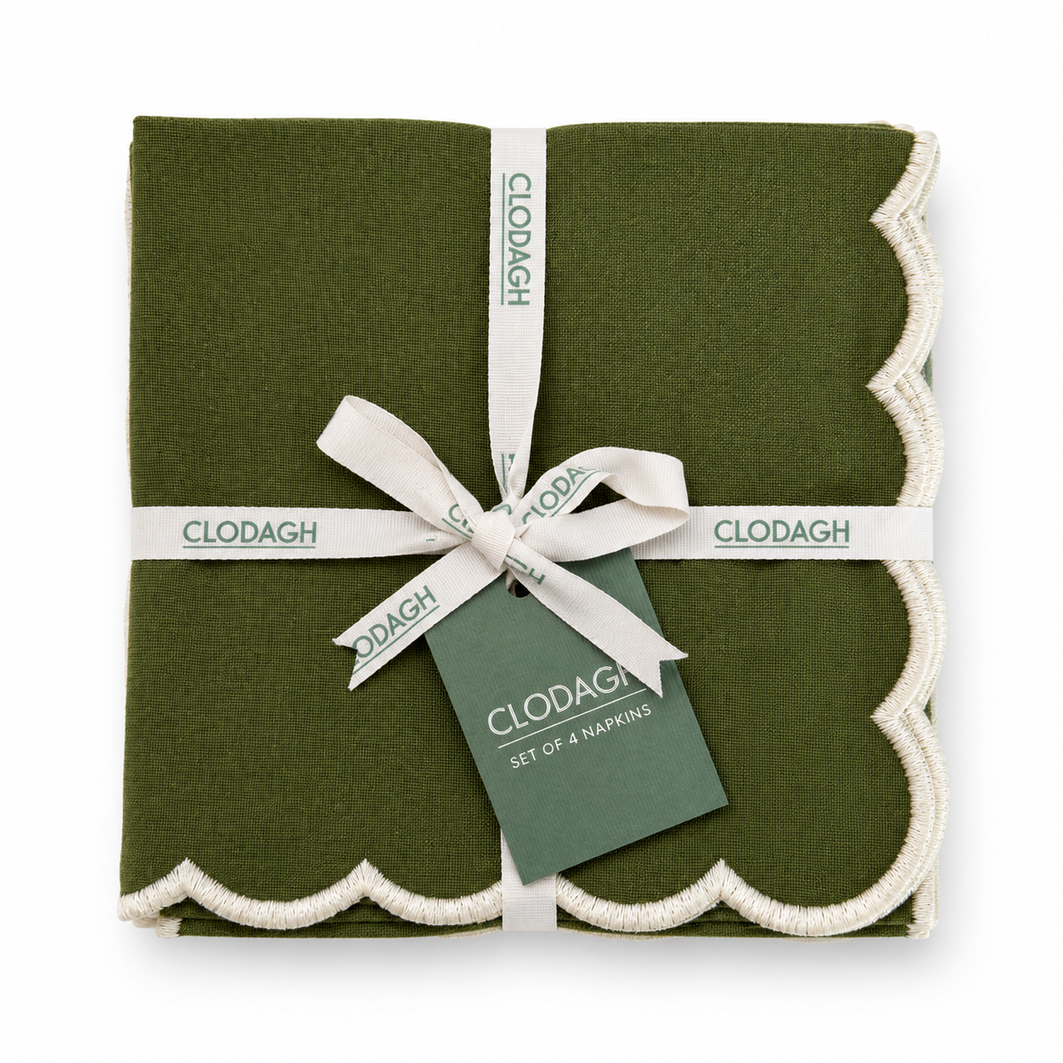 A folded set of four olive green napkins with cream scalloped edges, wrapped in a white ribbon and tag by CLODAGH.