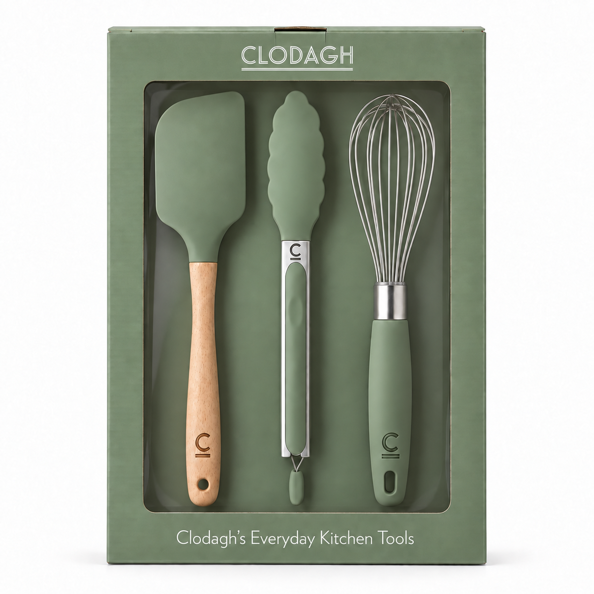 Clodagh Everyday Kitchen Tools set in a sage green box, containing a spatula with a light wood handle, a pebble-shaped scraper with a silver handle, and a whisk with a sage green handle.