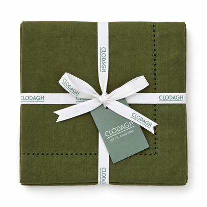 A set of four olive green linen napkins with embroidered dotted borders, wrapped in a white ribbon with CLODAGH branding and a matching gift tag, on a white background.
